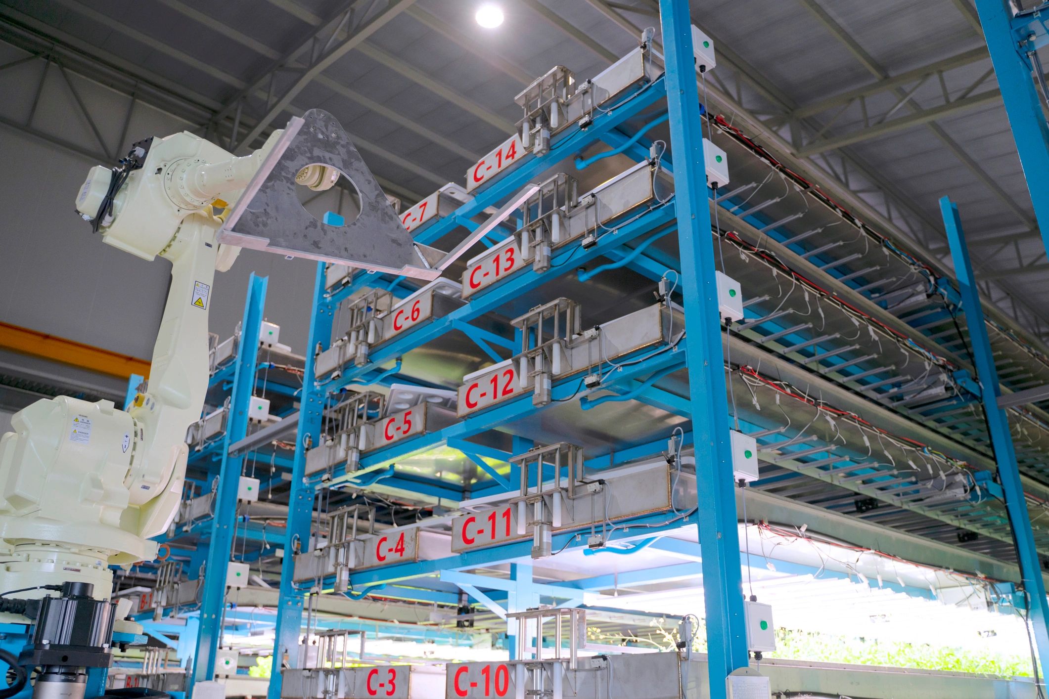 Employee are working with robotic arm.